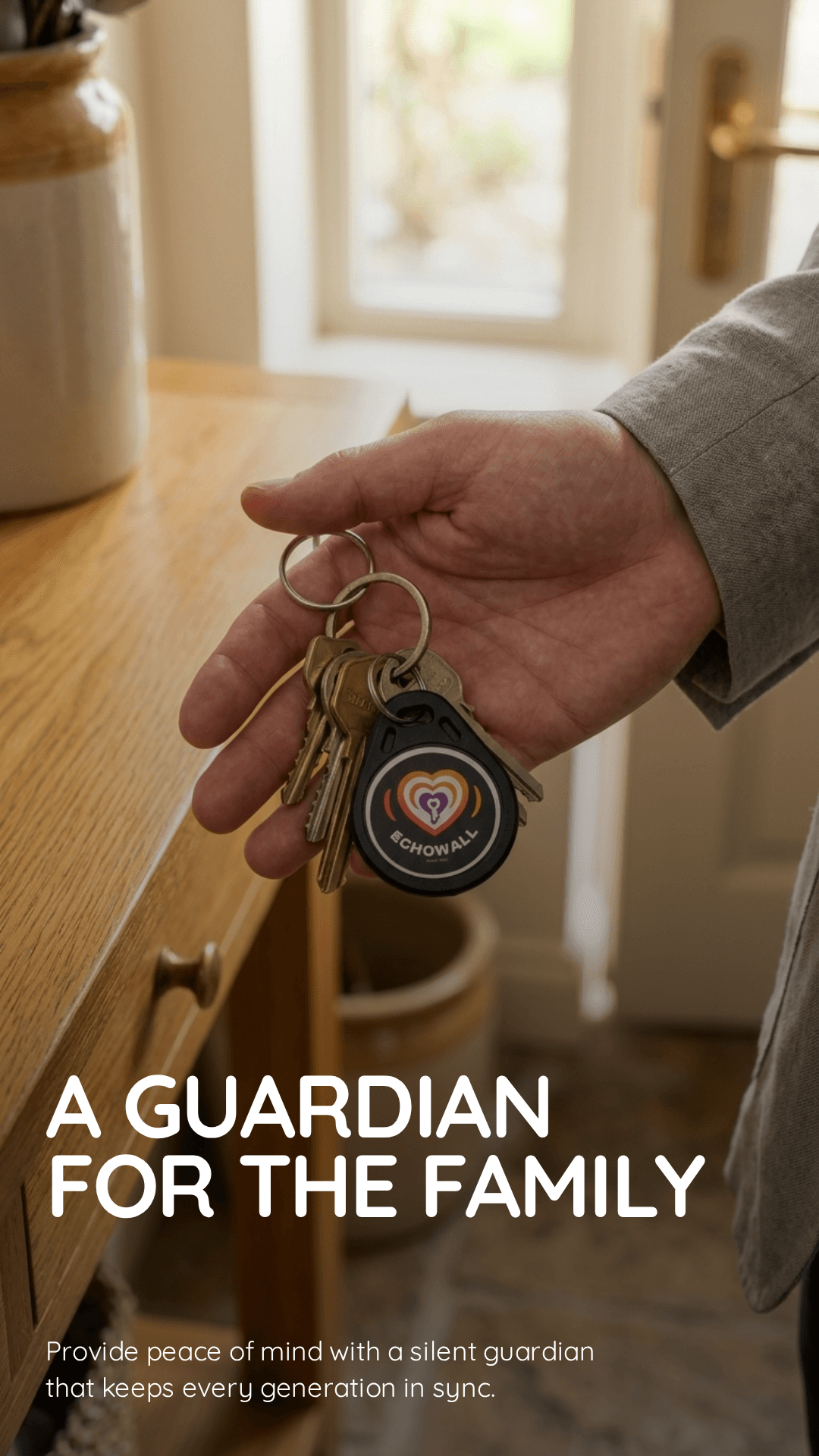 An EchoWall key held with family house keys near a doorway.